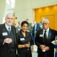 Guests in the Grand Gallery holding drinks at Enrichment.